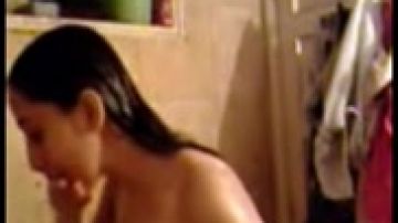 Attractive woman disrobes and takes a shower
