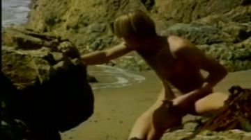 Guy jerks off his cock beside a beach