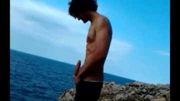 Dark-haired man shows off his cock