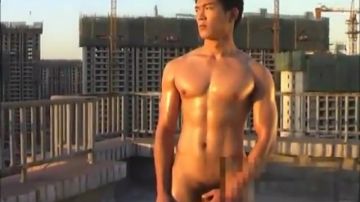 Naughty Asian man wanks against city backdrop